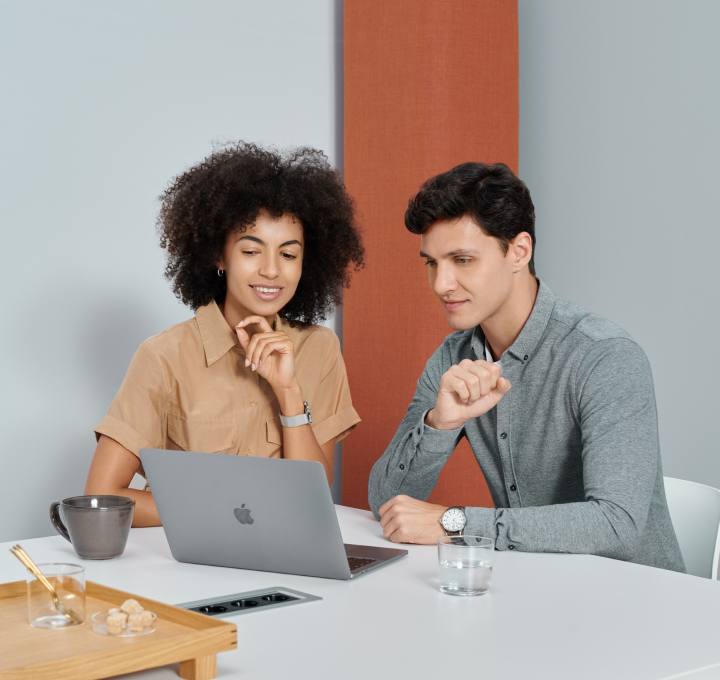 Mute Legal - Interior with people in front of a Macbook