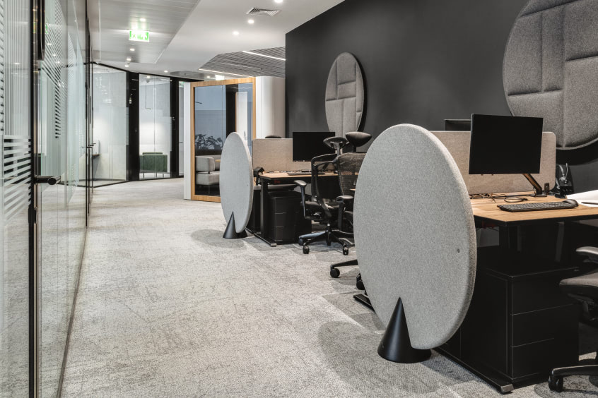 CMS Warsaw - Cone Acoustic Screens besides Desks